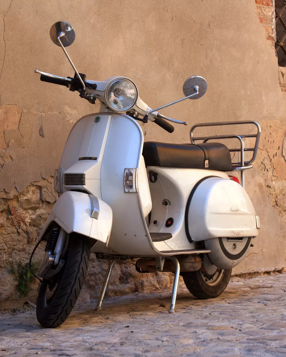 vespa grigia contro muro